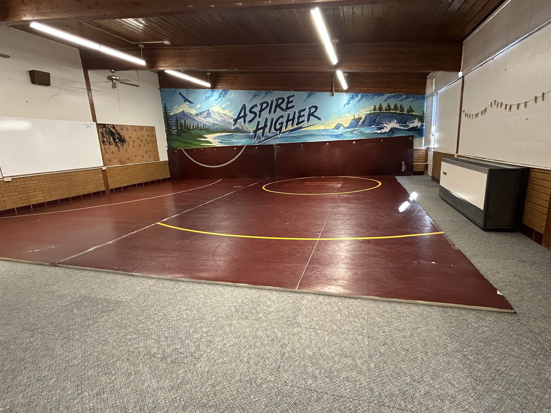 Wide view of the Athletic Room and wrestling mats