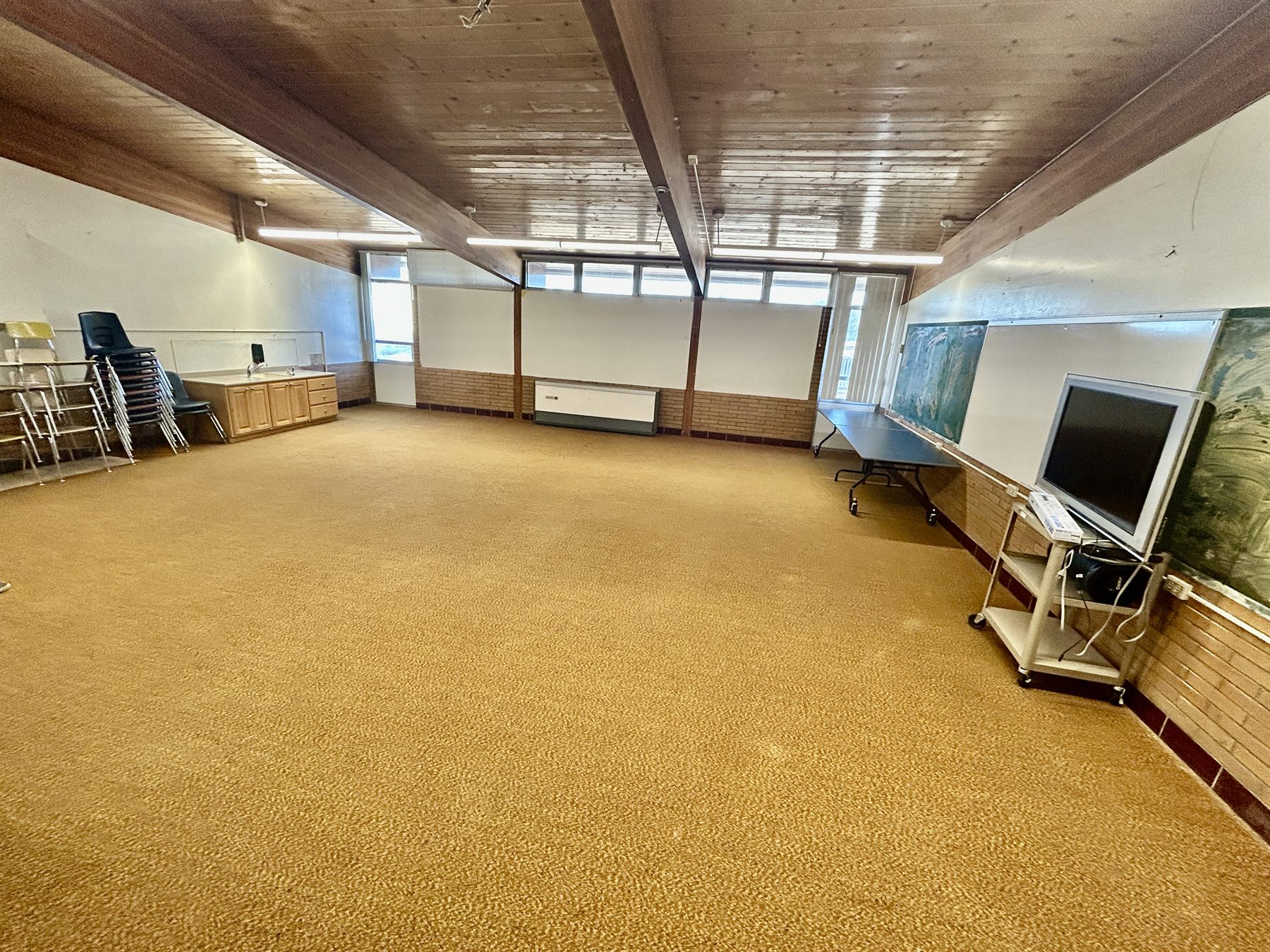 Standard classroom with open floor space and a television