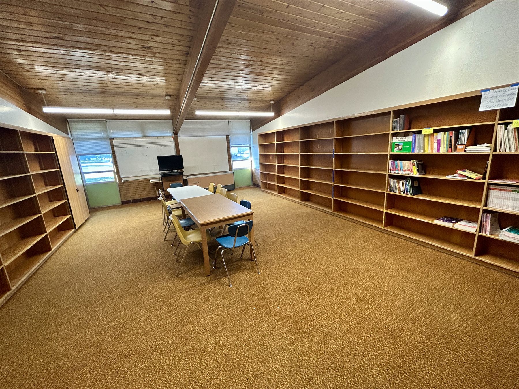 Library room with bookshelves, tables, and chairs